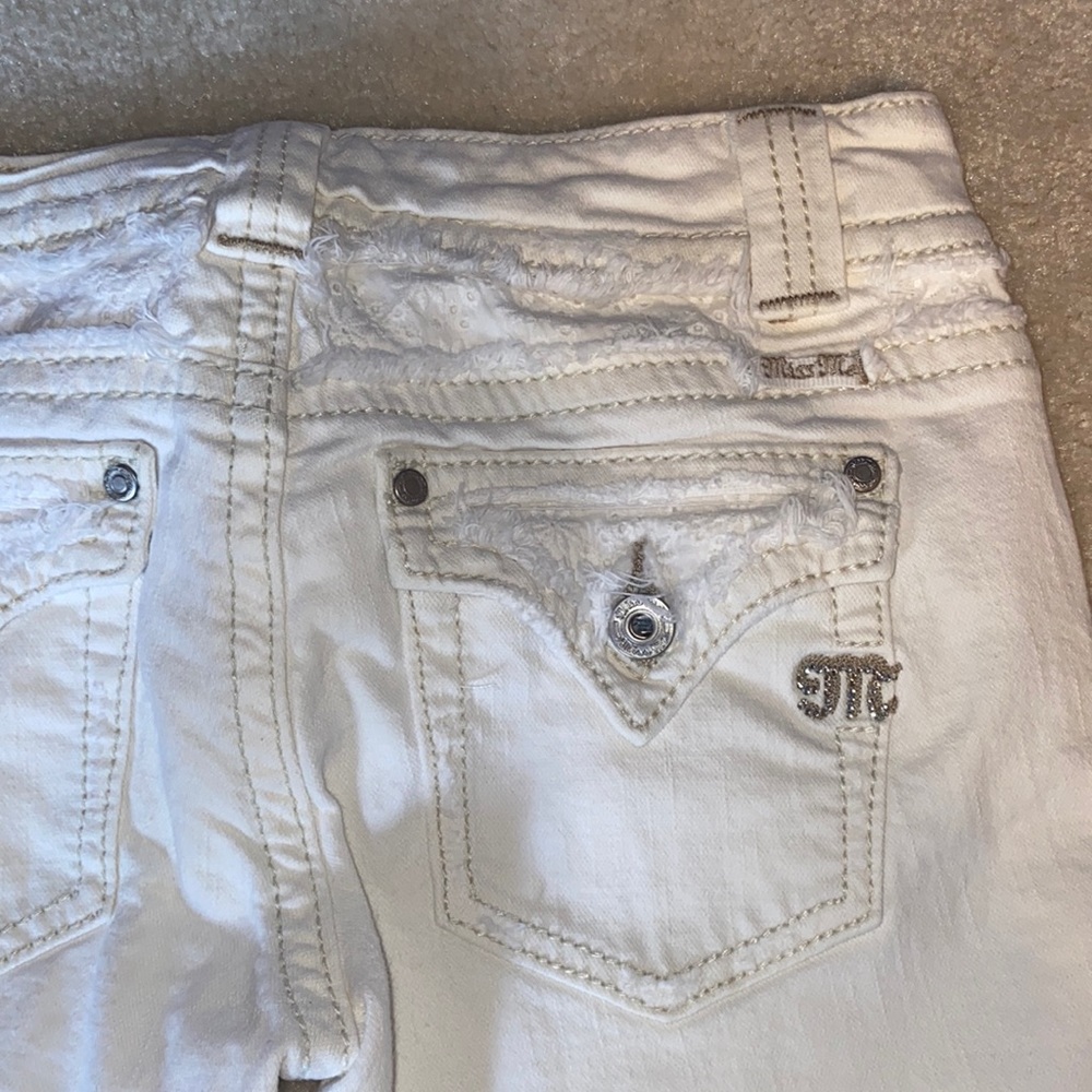 Miss Me capri jeans with lace on bottoms and back pockets.